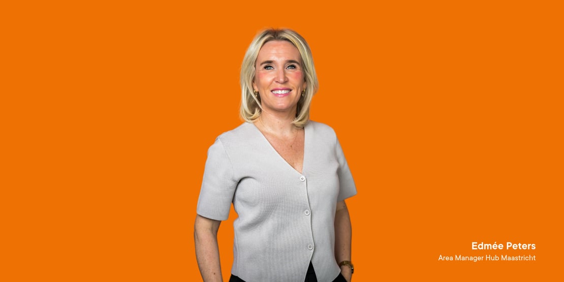 Edmée Peters, Area Manager bij Wiertz Company, tegen een oranje achtergrond.